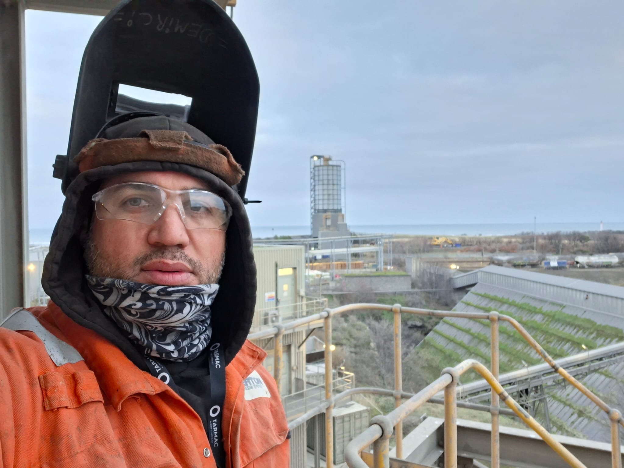 Murat Demirci in orange hi-vis on an industrial site